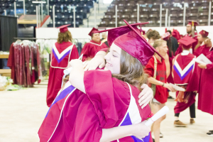 Graduates congratulate their classmates following the convocation at Credit Union Place, last week.