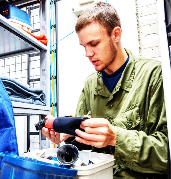 Cadet Flight Sergeant Levi Layh inspects a bear safety kit, checking its condition and ensuring expiry dates are valid, at Cold Lake Cadet Training Centre in Cold Lake, Alberta on July 9, 2026